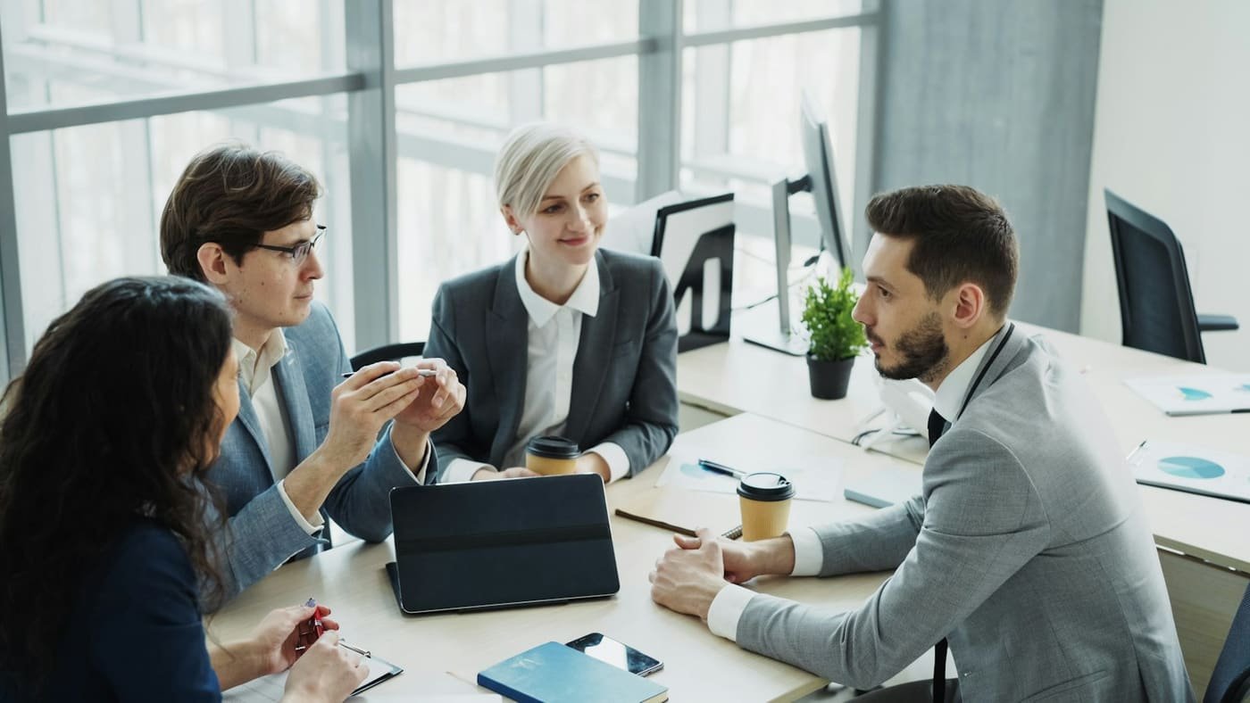 Business team in a meeting around a table in a modern office