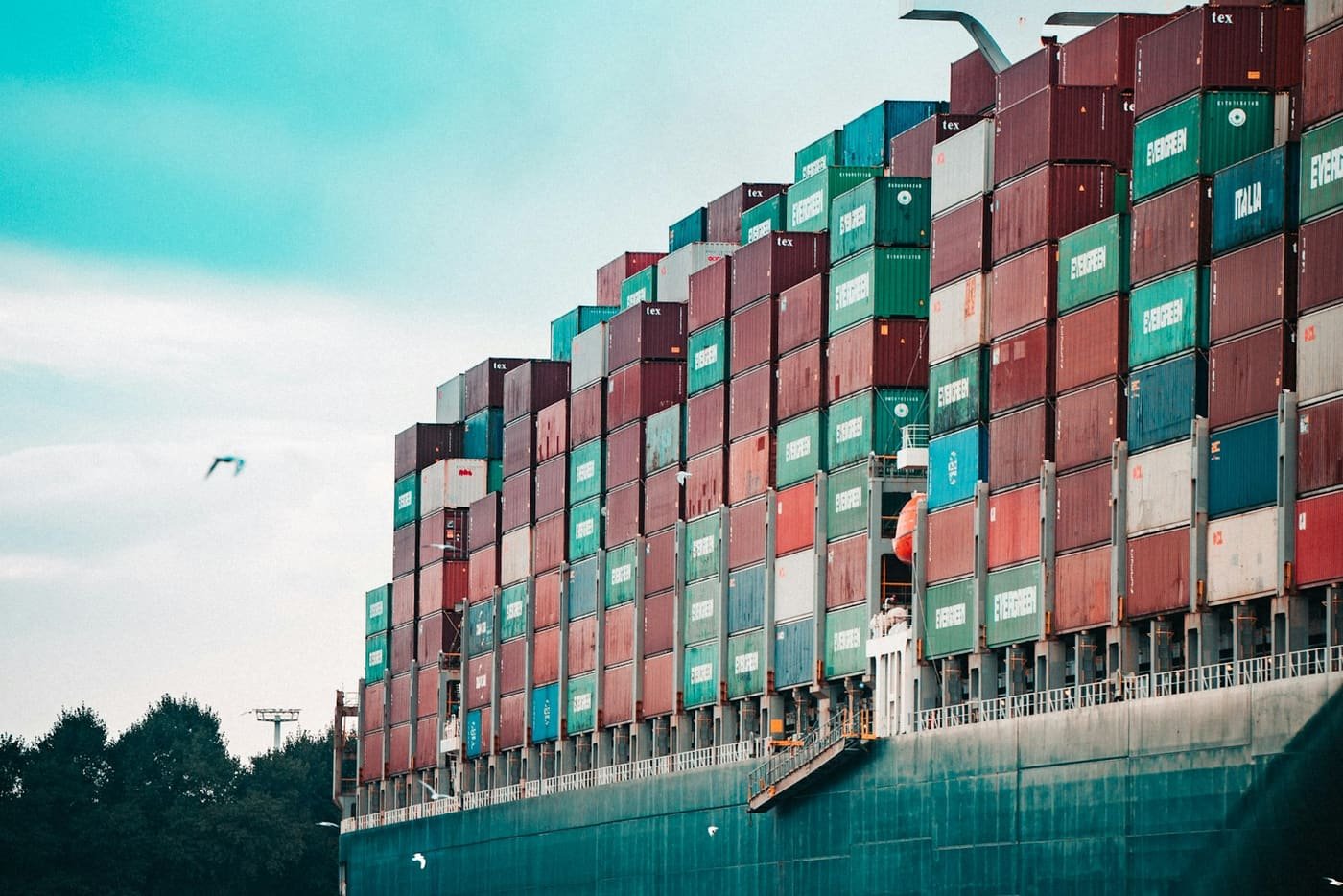 Side view of a cargo ship stacked high with containers