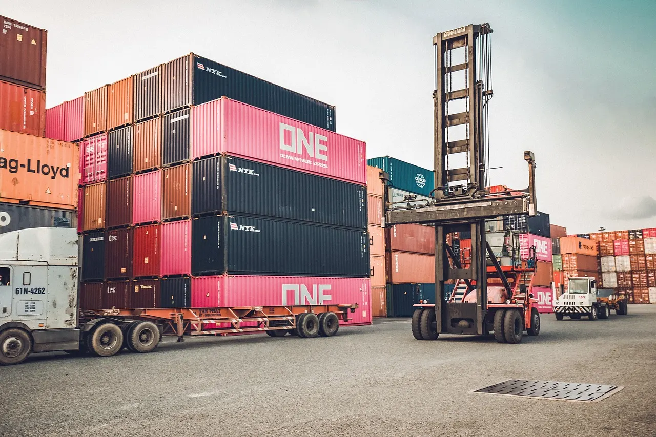 Container handler and truck working in a port container yard during cargo handling