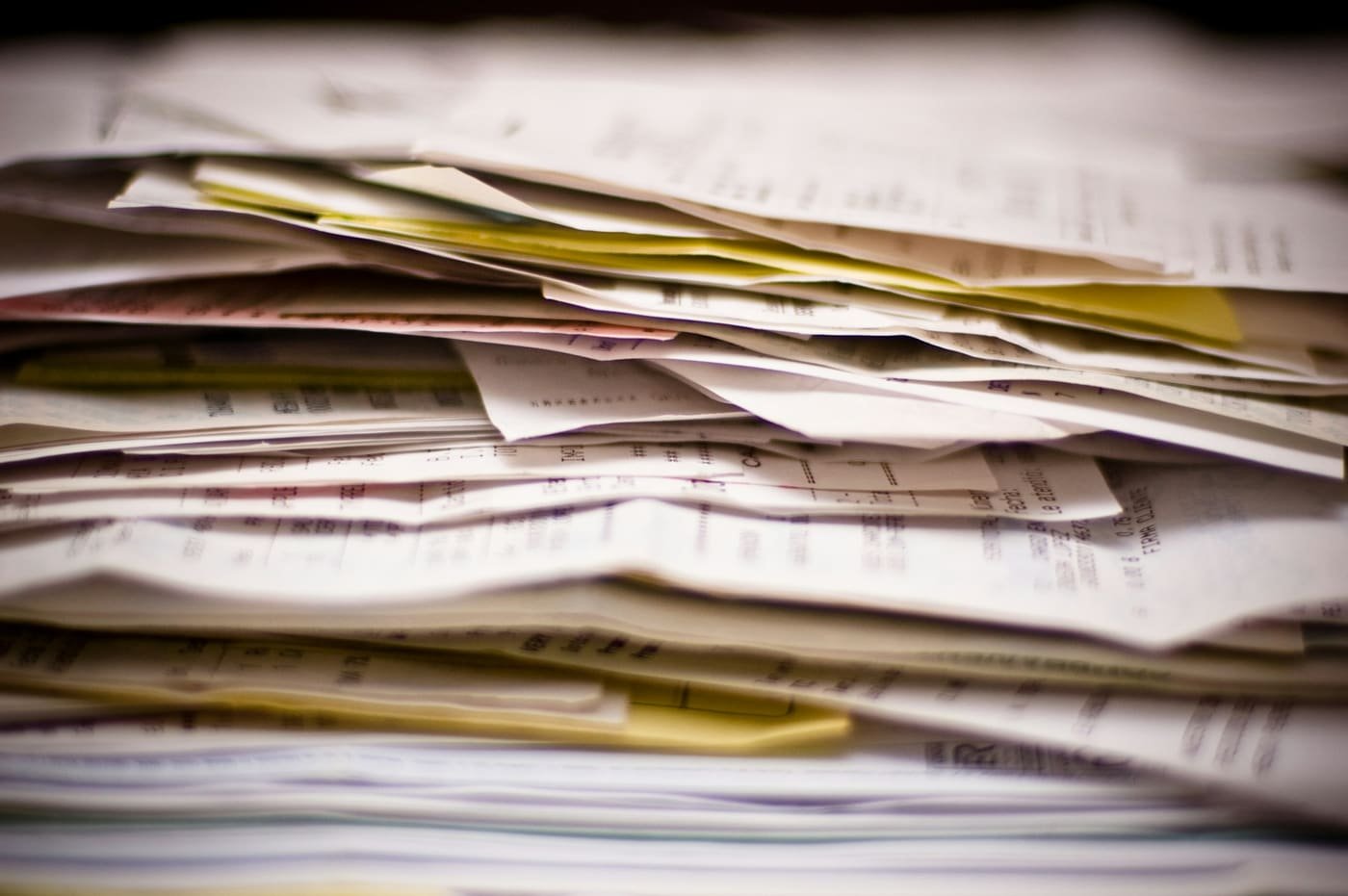 Thick stack of printed invoices, receipts and other documents