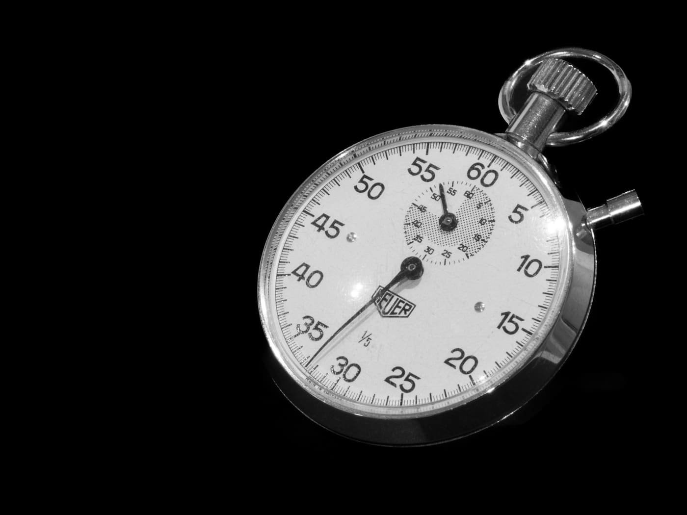 Analogue stopwatch on a black background