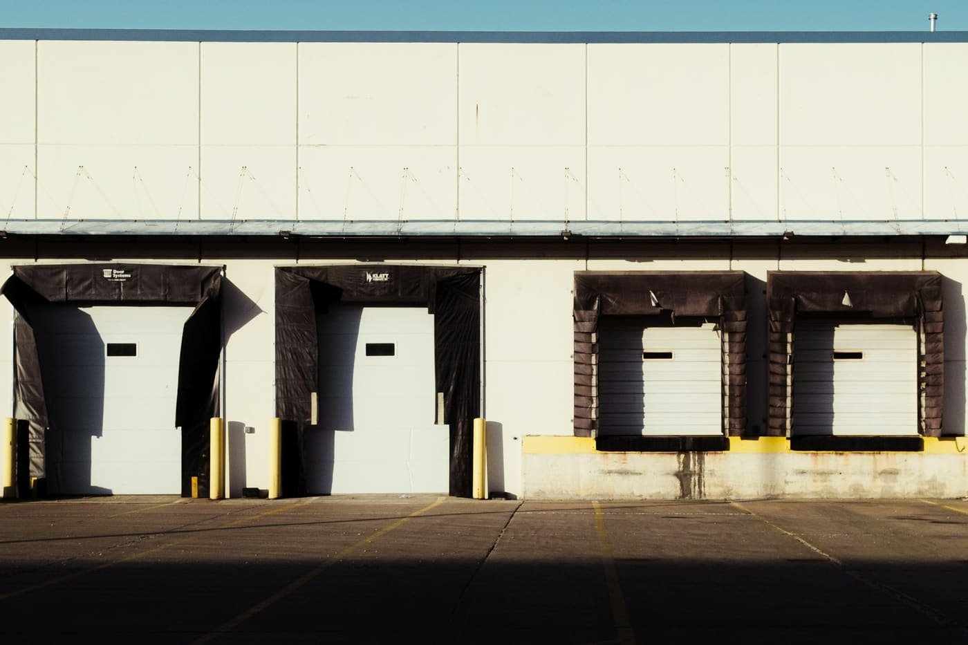 Row of warehouse loading dock doors with dock shelters, illustrating cargo handling and consolidation