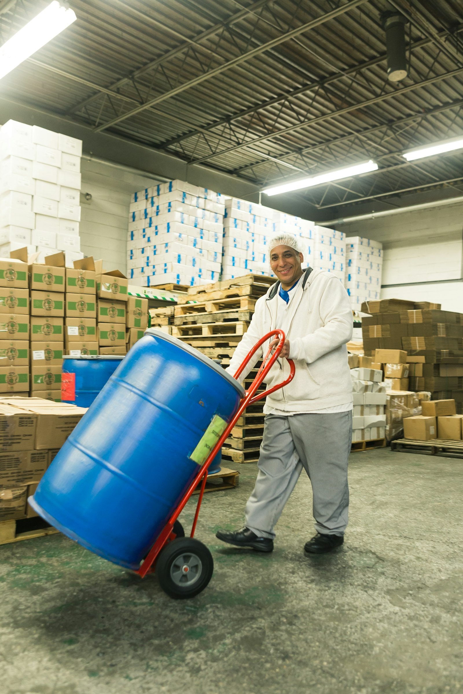 Warehouse worker handling cargo with manual handling equipment