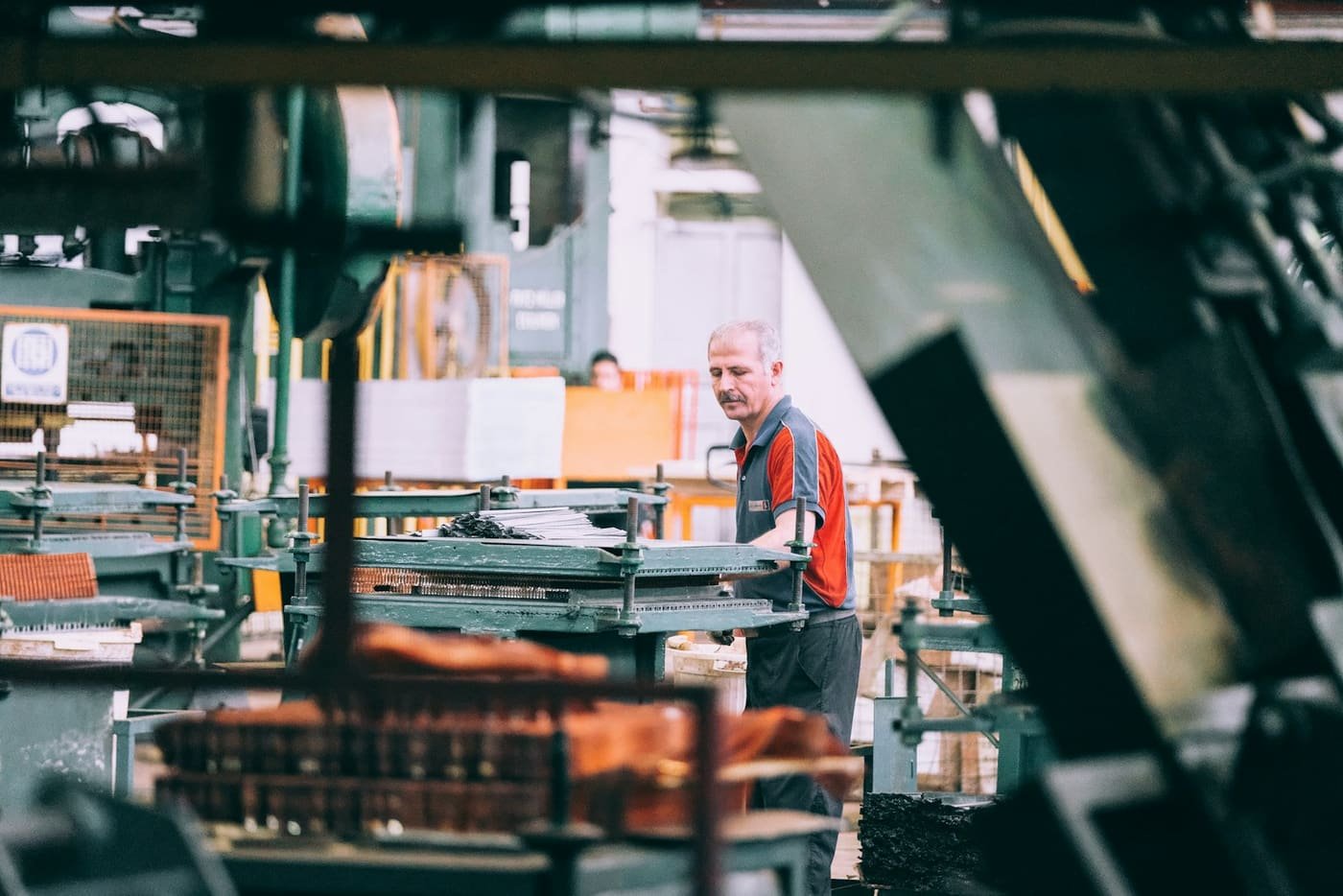 Worker operating industrial machinery in a factory