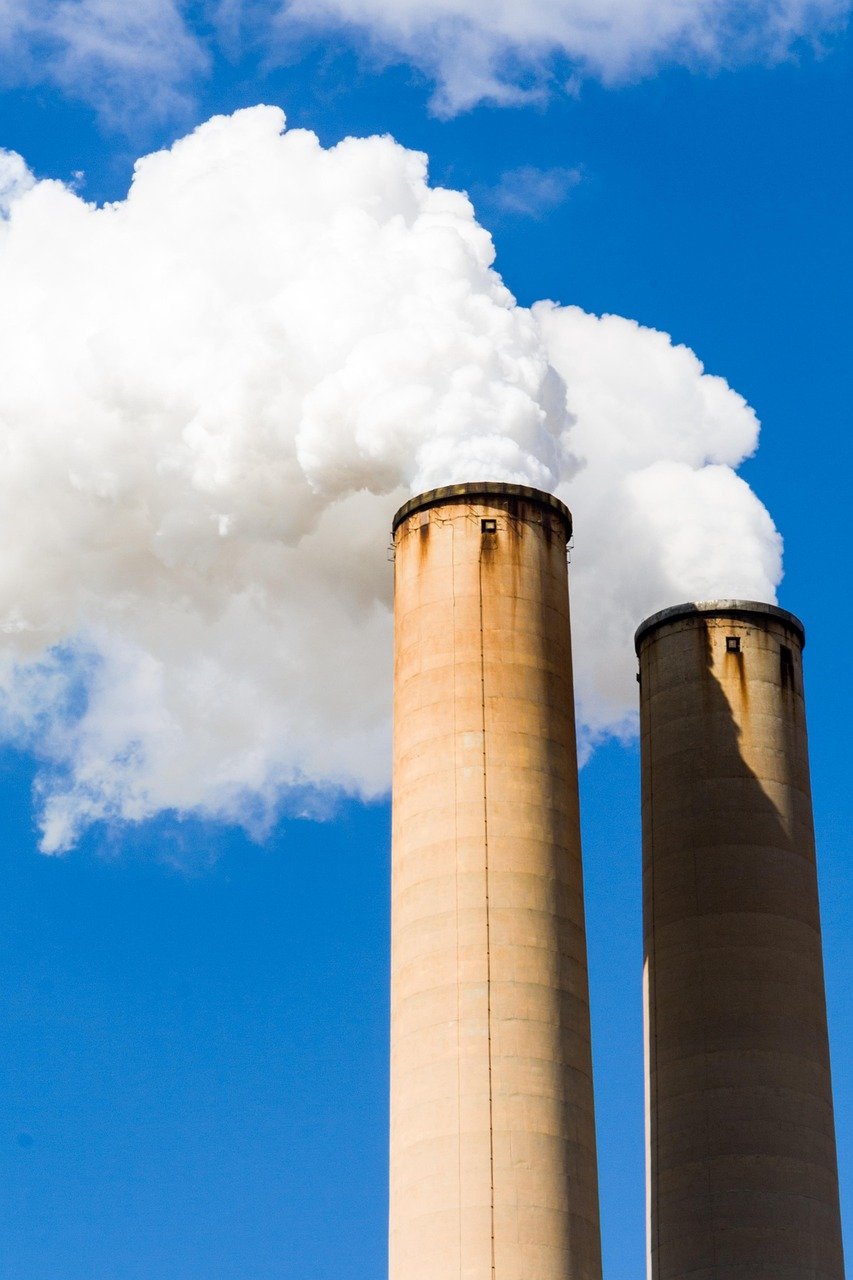 Industrial smokestacks emitting exhaust